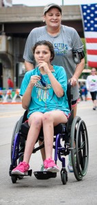 Mom Pushing Daughter In Wheelchair at Marathon